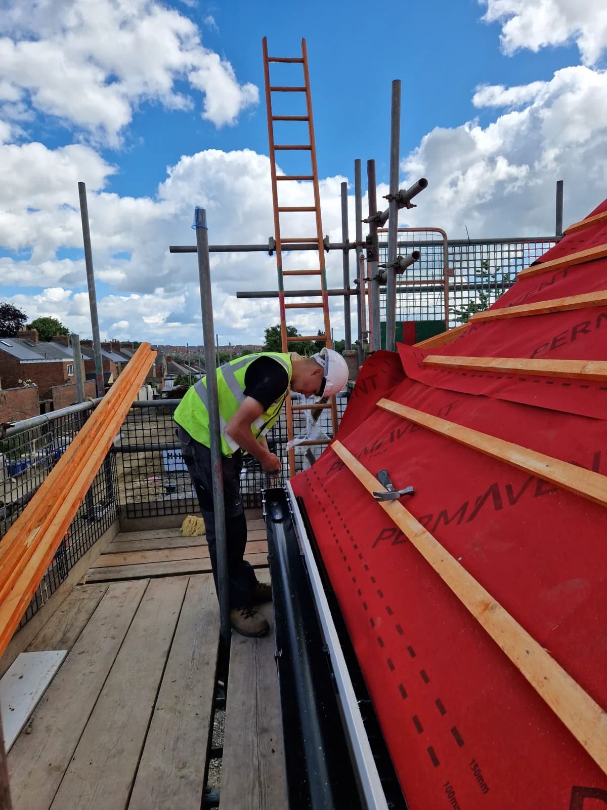 Roofer working on a roof in breather membrane and battens in the North East